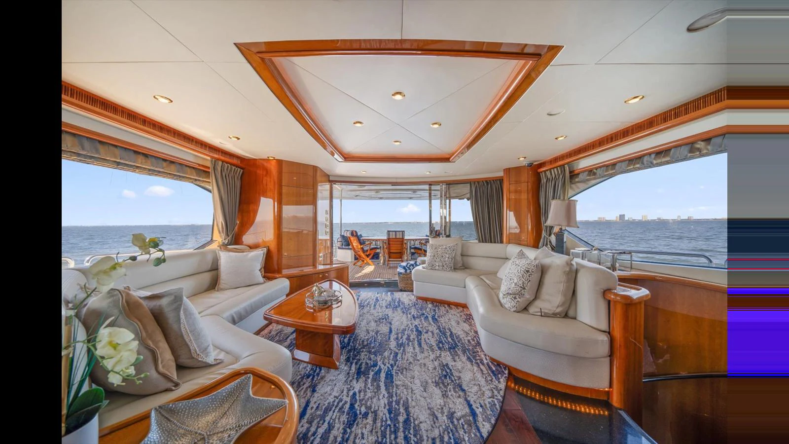 The yacht's salon features luxurious seating with panoramic views of the ocean. aboard VANGUARD Yacht for Sale