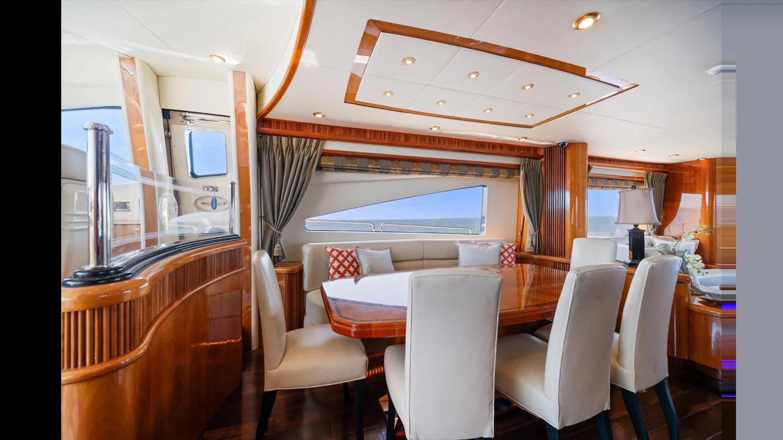 The yacht's dining area features elegant wood finishes and plush seating, creating a luxurious and inviting atmosphere. aboard VANGUARD Yacht for Sale