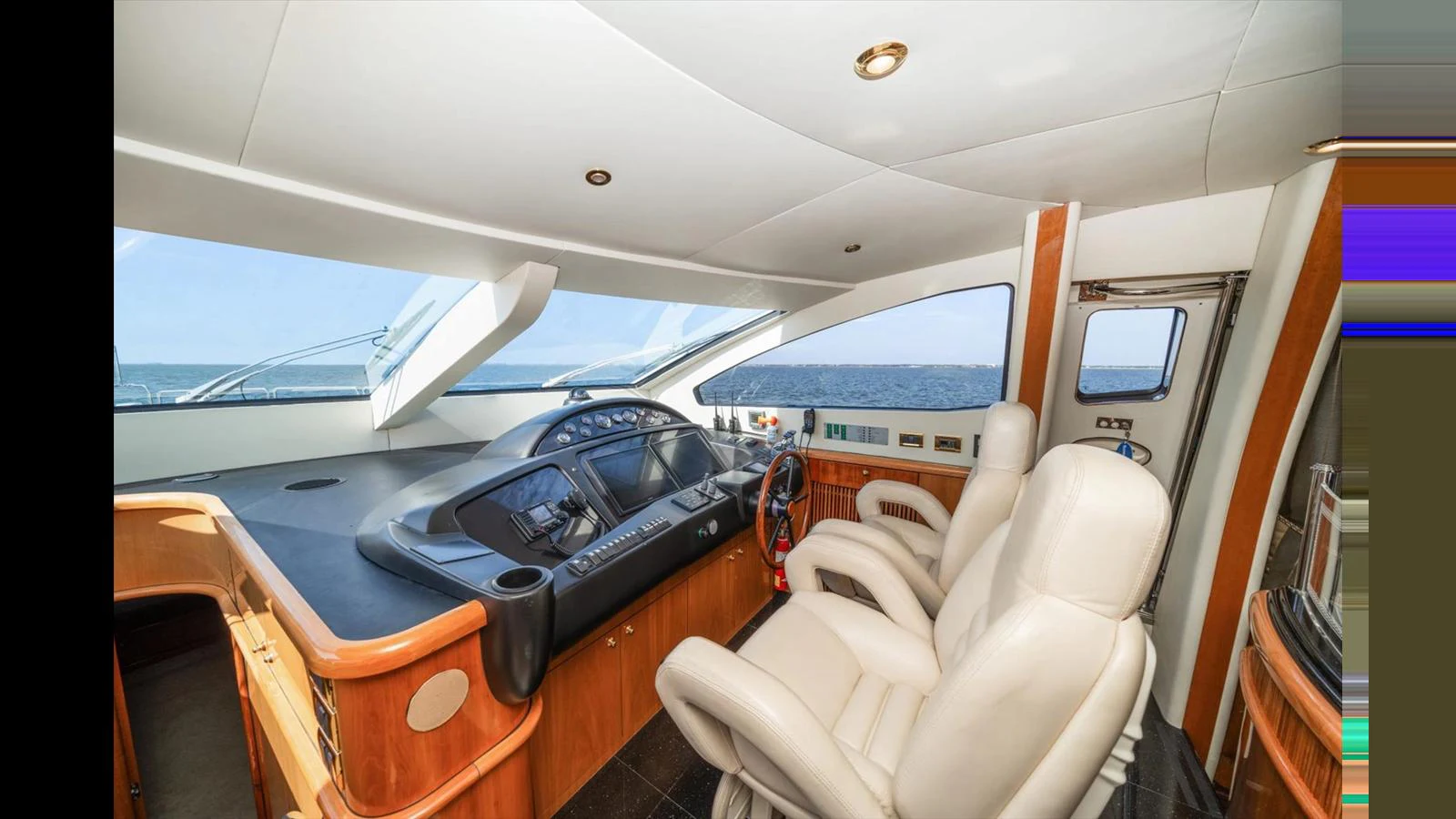 The yacht's helm features luxurious seating and advanced navigation equipment. aboard VANGUARD Yacht for Sale