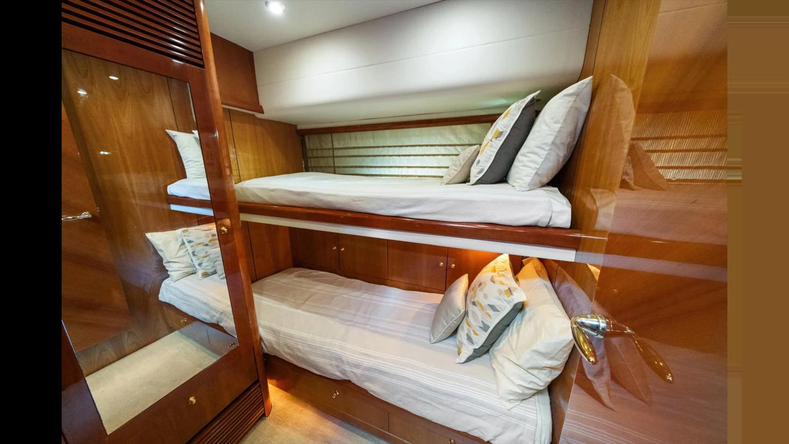 The cozy bunk cabin features warm wood tones and comfortable bedding, perfect for restful nights at sea. aboard VANGUARD Yacht for Sale