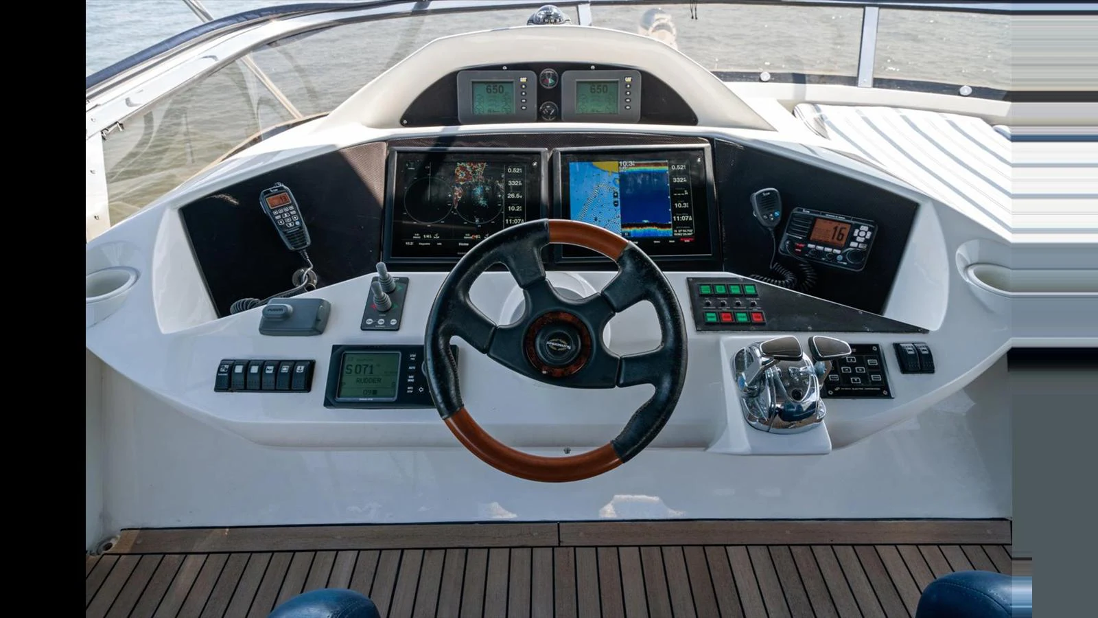 The helm station features advanced navigation equipment and a sleek steering wheel, ensuring precise control and a modern aesthetic. aboard VANGUARD Yacht for Sale