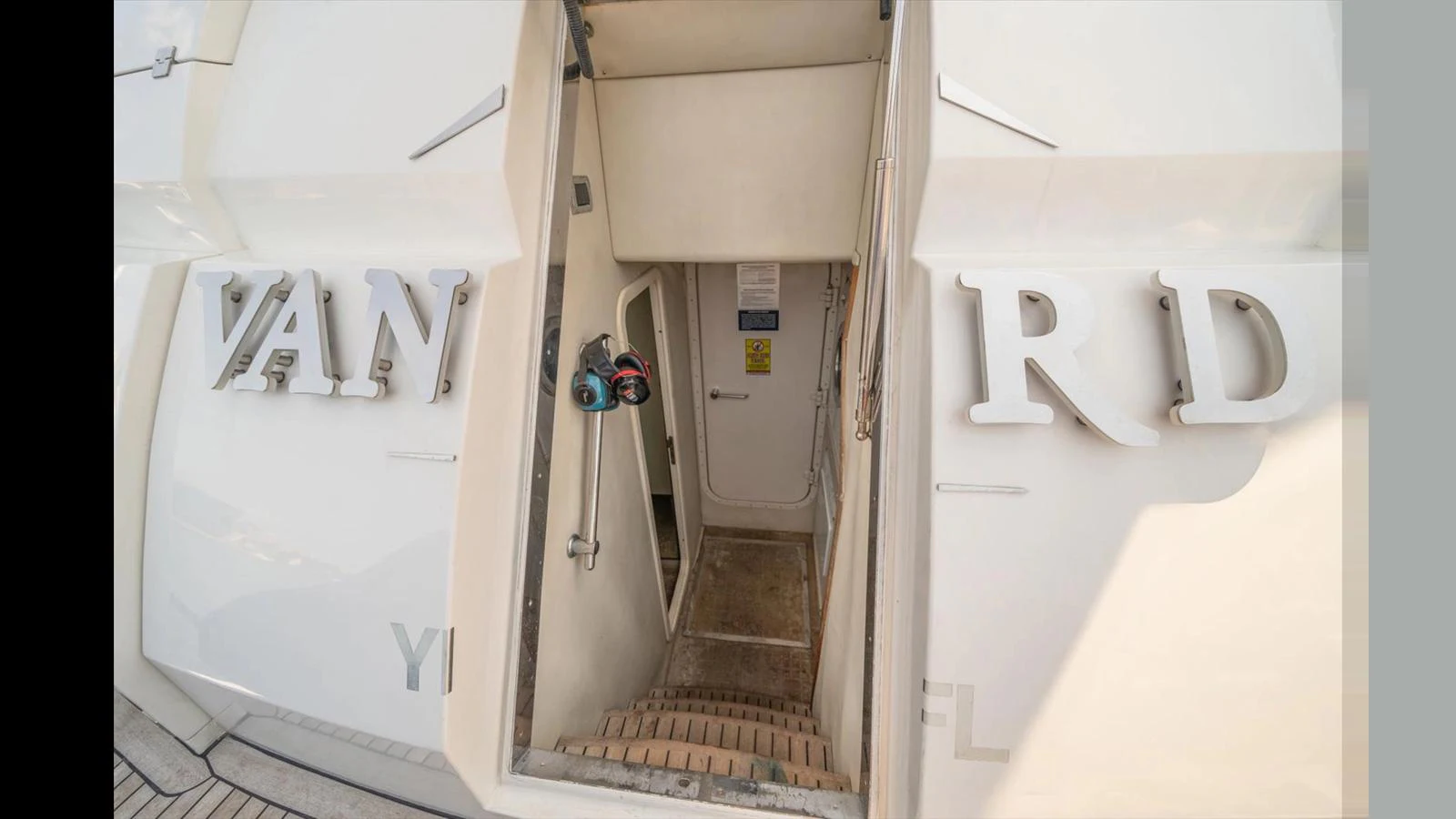 A close-up view of the yacht's entryway with visible stairs leading below deck. aboard VANGUARD Yacht for Sale