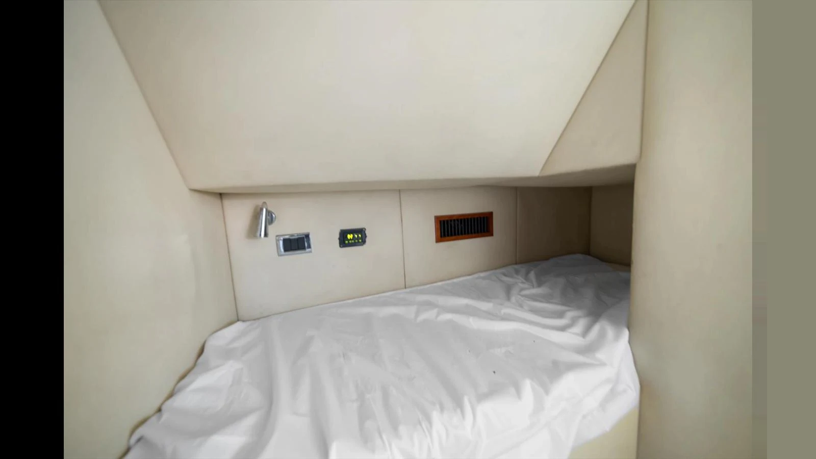 A cozy cabin with a single bed and modern amenities. aboard VANGUARD Yacht for Sale