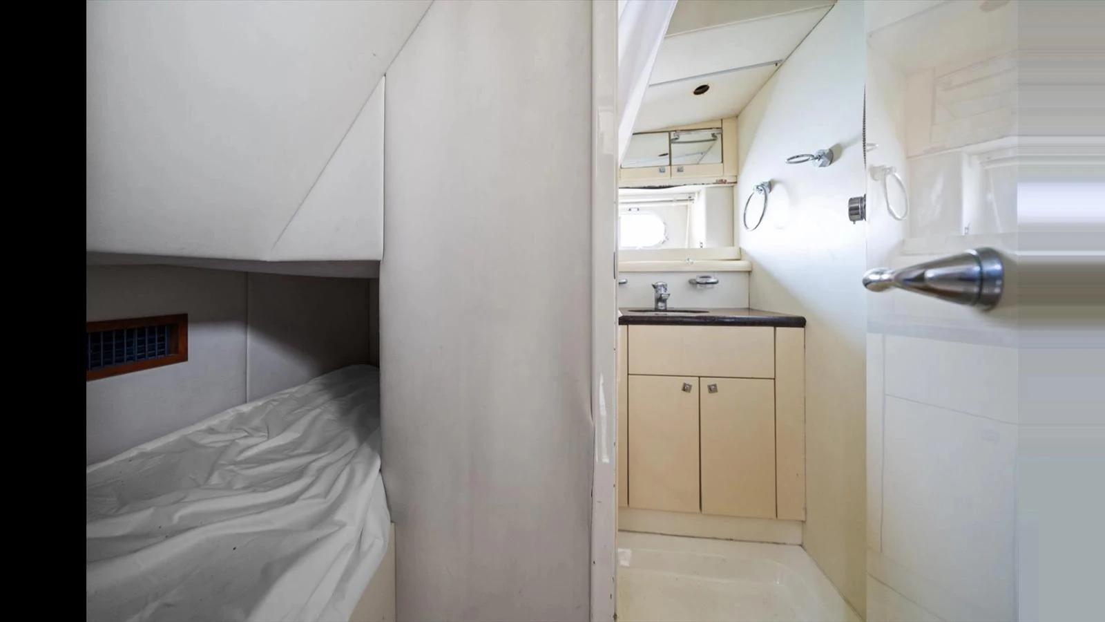 The image shows a cozy cabin area with a small sink and storage cabinets. aboard VANGUARD Yacht for Sale