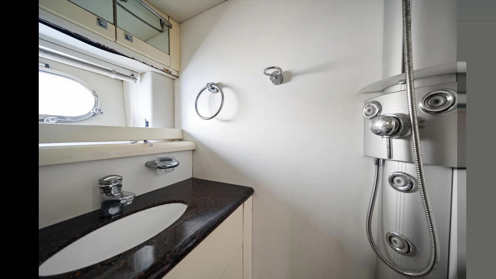 A sleek and modern yacht bathroom featuring a stylish sink and a contemporary shower setup. aboard VANGUARD Yacht for Sale