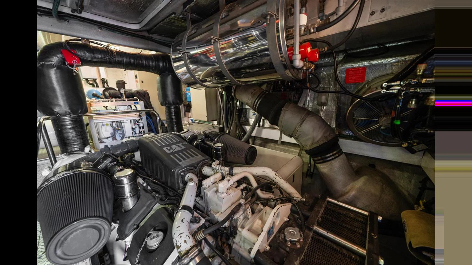 The image showcases the yacht's engine room with its intricate machinery and components. aboard VANGUARD Yacht for Sale
