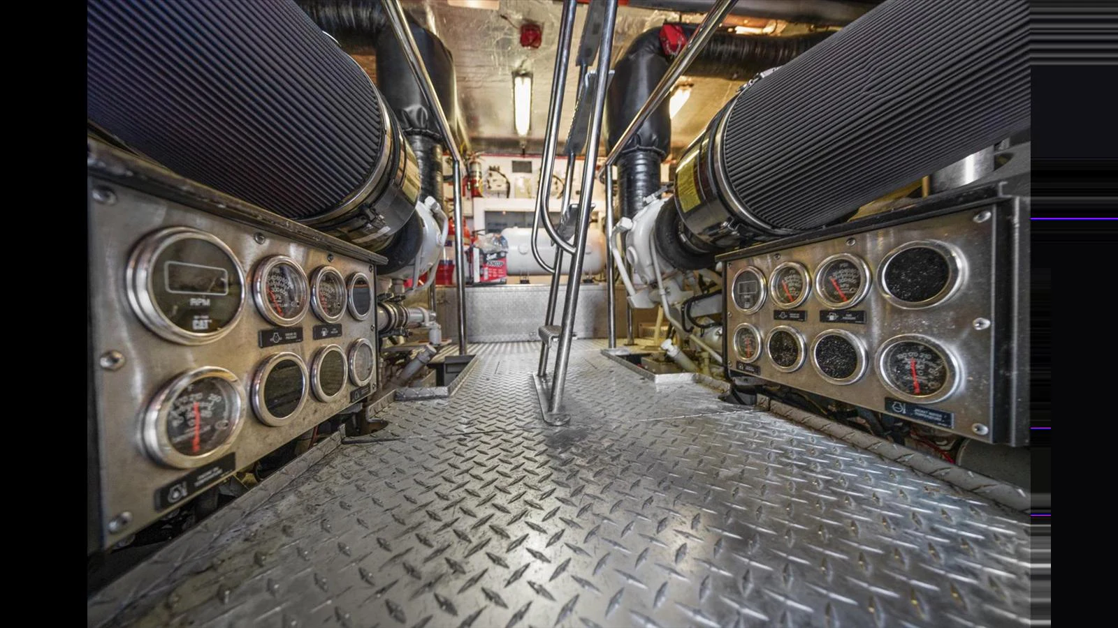 The image showcases the yacht's engine room with detailed control panels and machinery. aboard VANGUARD Yacht for Sale
