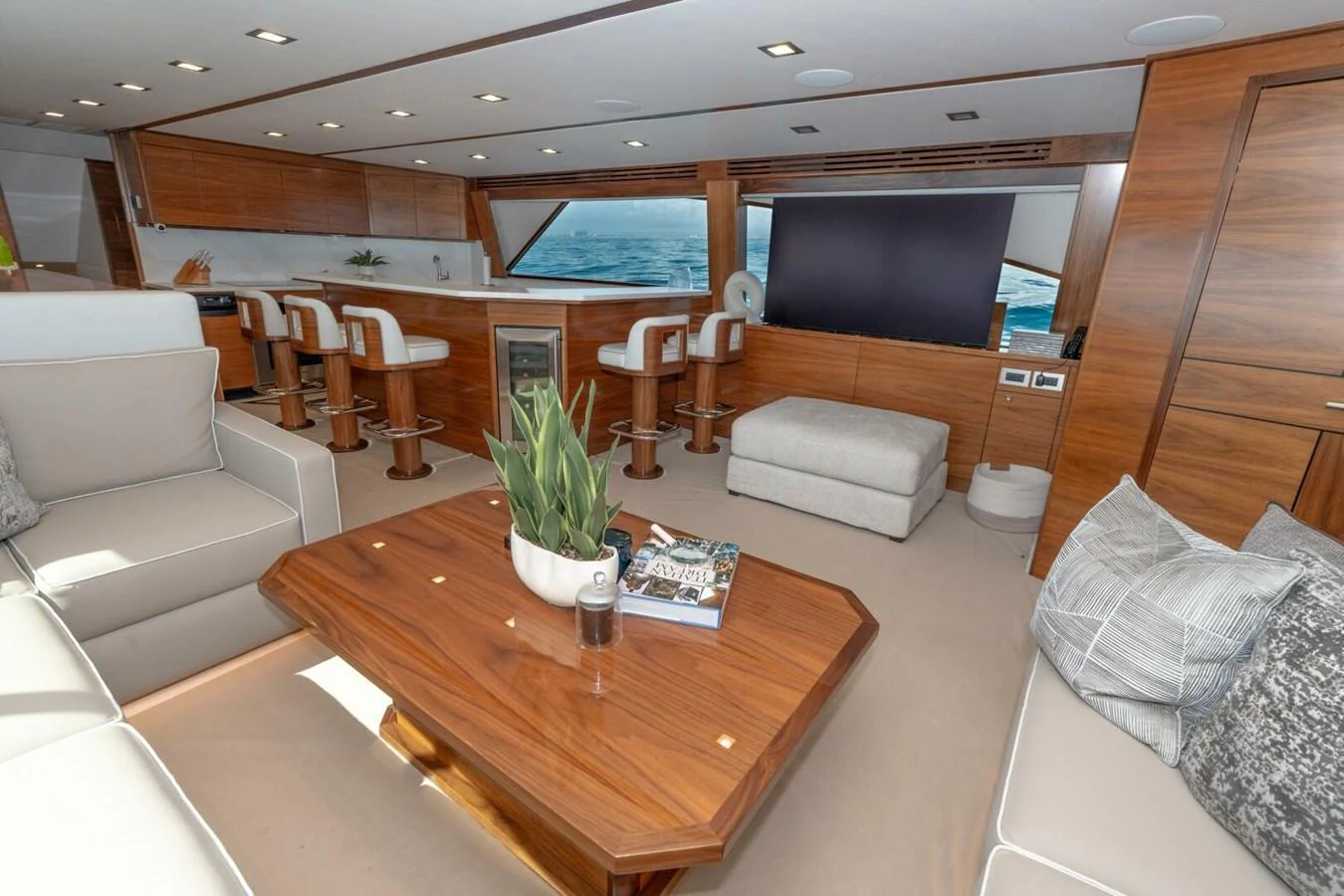 a living room with a table and couches aboard ZATARA Yacht for Sale