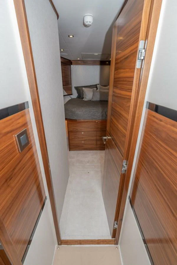 a hallway with a bed and a door aboard ZATARA Yacht for Sale