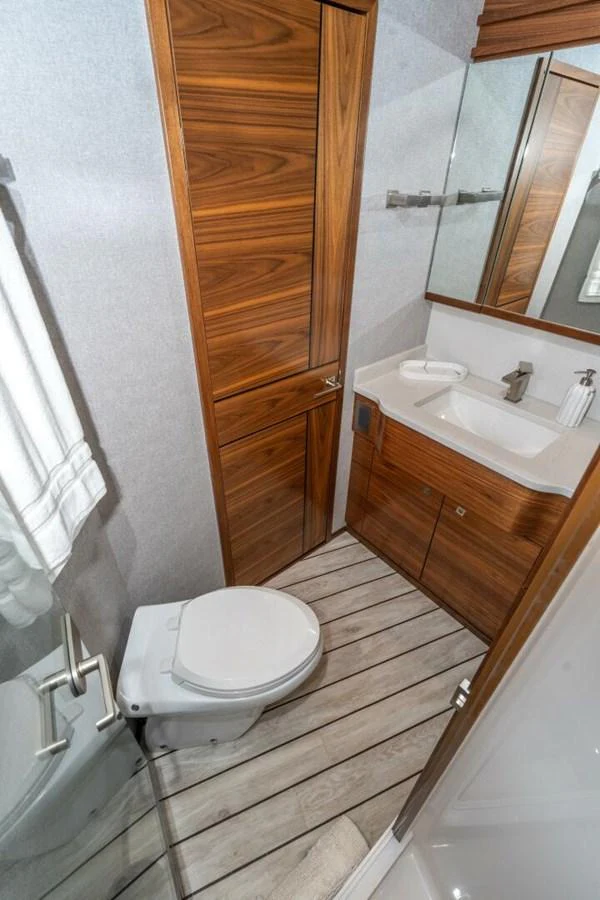 a bathroom with a wood door aboard ZATARA Yacht for Sale