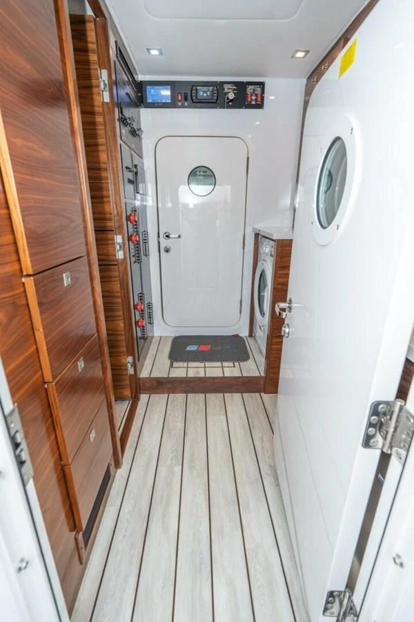 a hallway with a door and a mirror aboard ZATARA Yacht for Sale