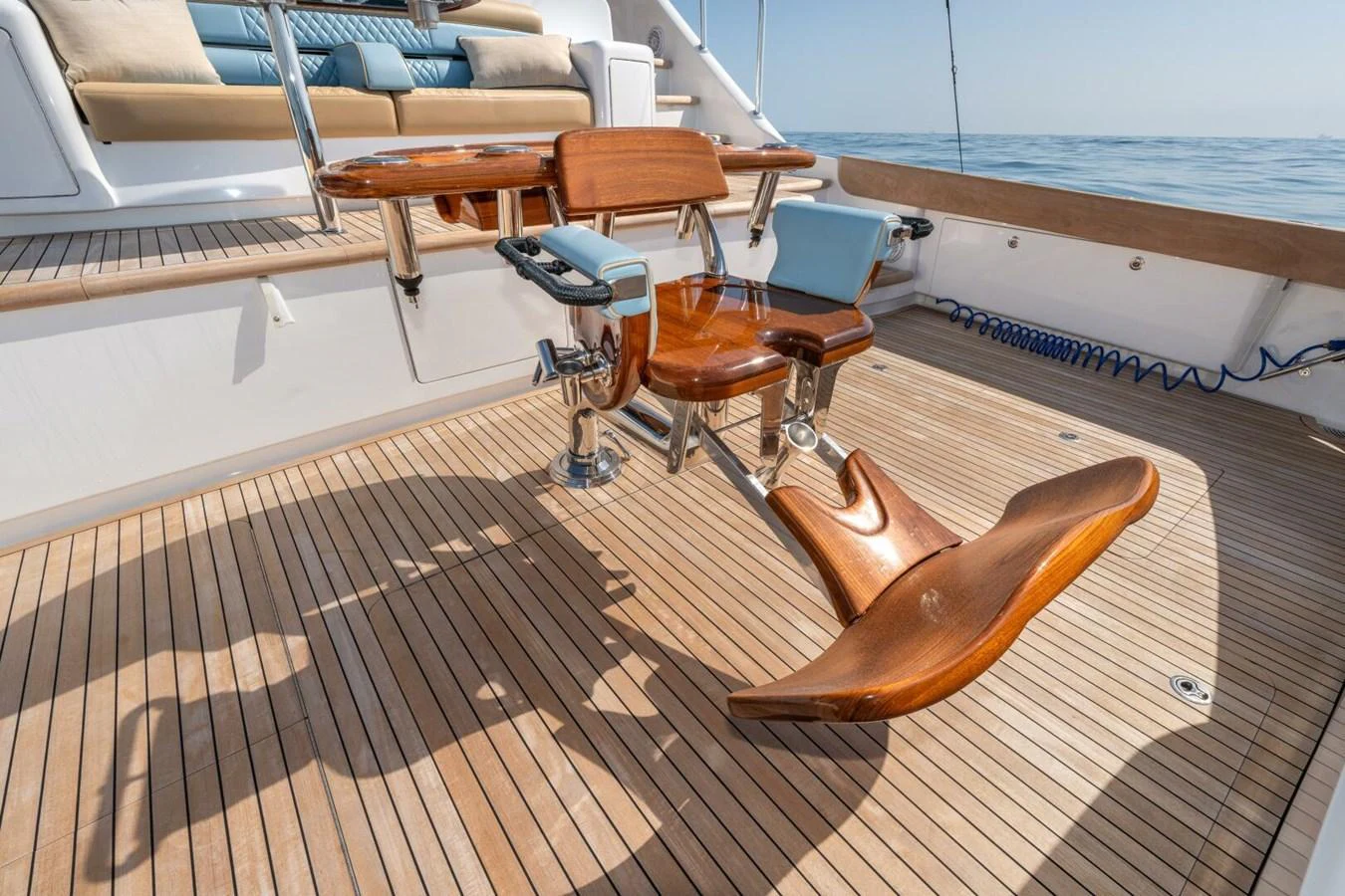 a wooden deck with chairs and a table on it aboard ZATARA Yacht for Sale