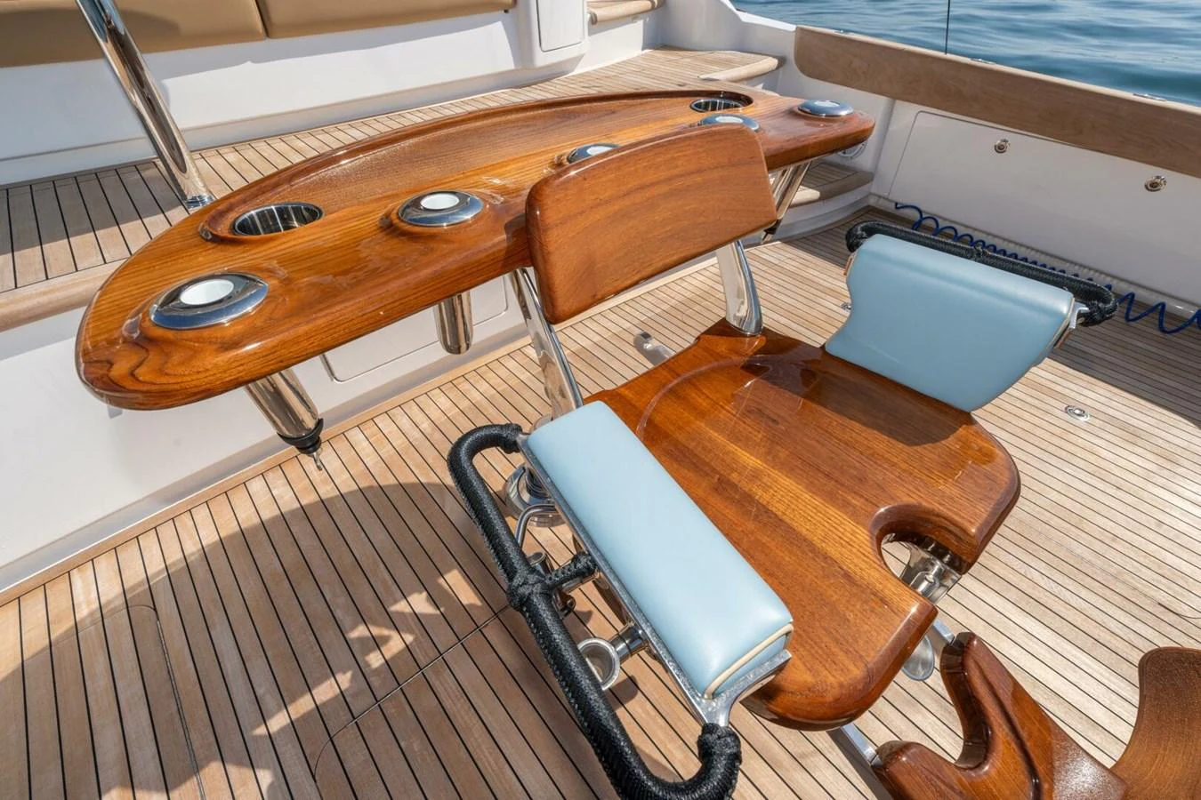 a wooden table with a metal frame aboard ZATARA Yacht for Sale