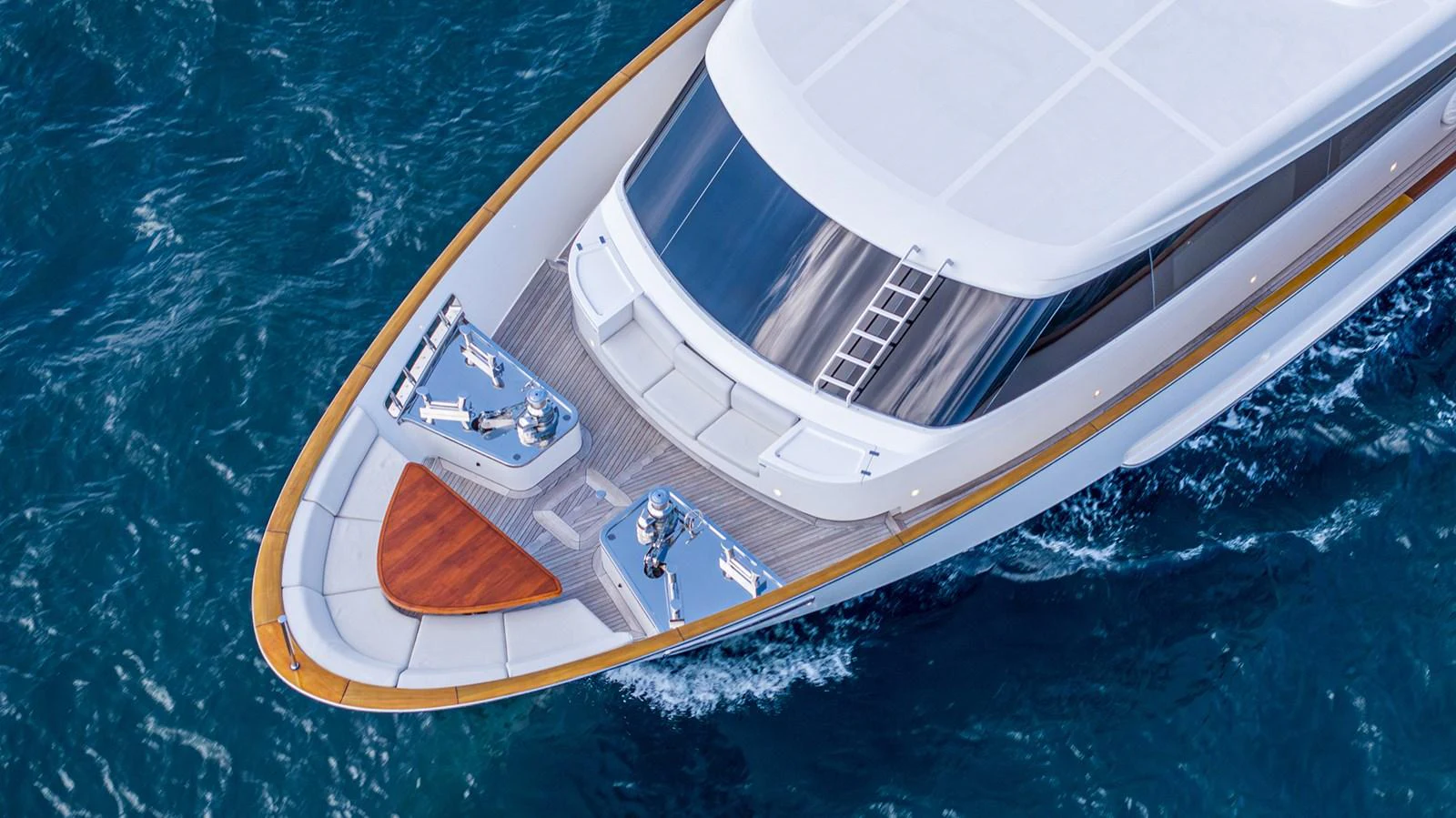 A pristine yacht bow glides through the deep blue sea, showcasing sleek design and craftsmanship. aboard BETTY JANE Yacht for Sale