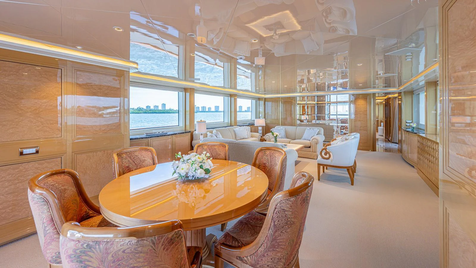 The salon features elegant furnishings and expansive windows offering stunning views. aboard BETTY JANE Yacht for Sale