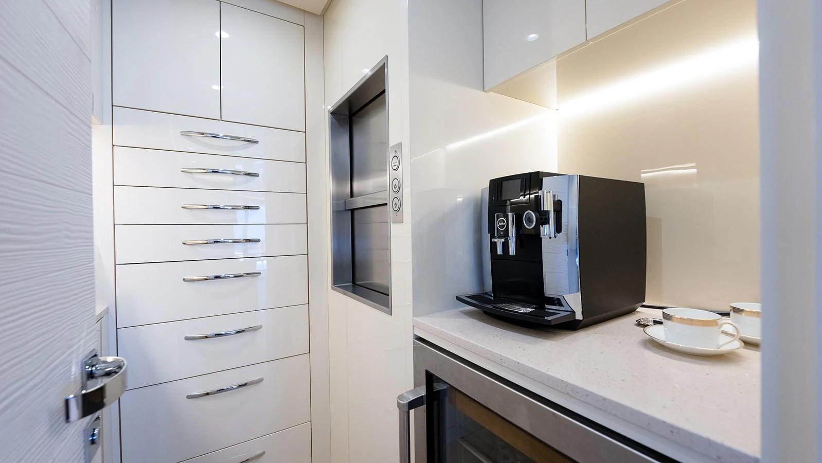 A sleek and modern galley featuring a coffee machine and ample storage space. aboard BETTY JANE Yacht for Sale