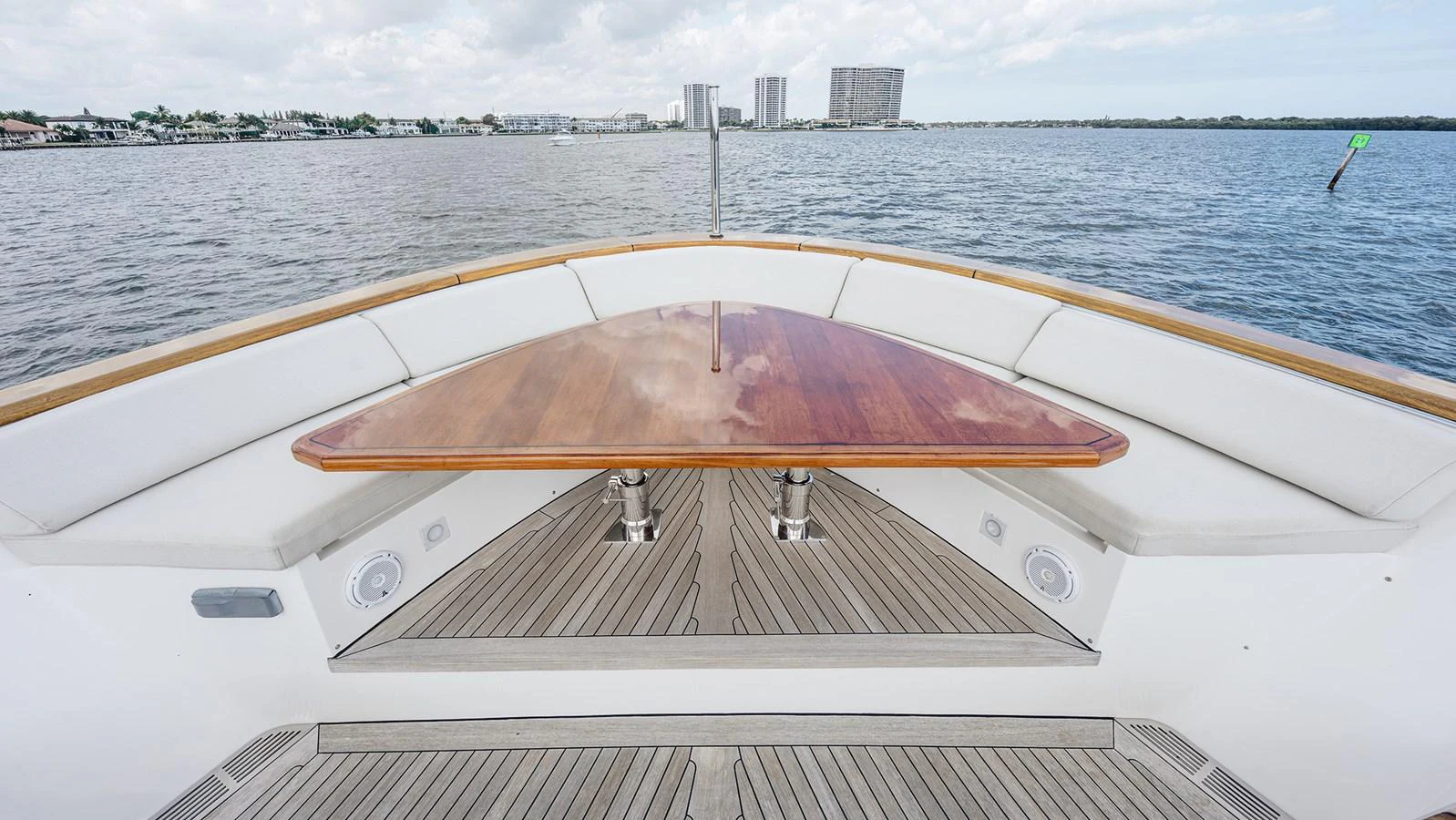 The yacht's bow features a sleek wooden table and comfortable seating, perfect for enjoying scenic views. aboard BETTY JANE Yacht for Sale