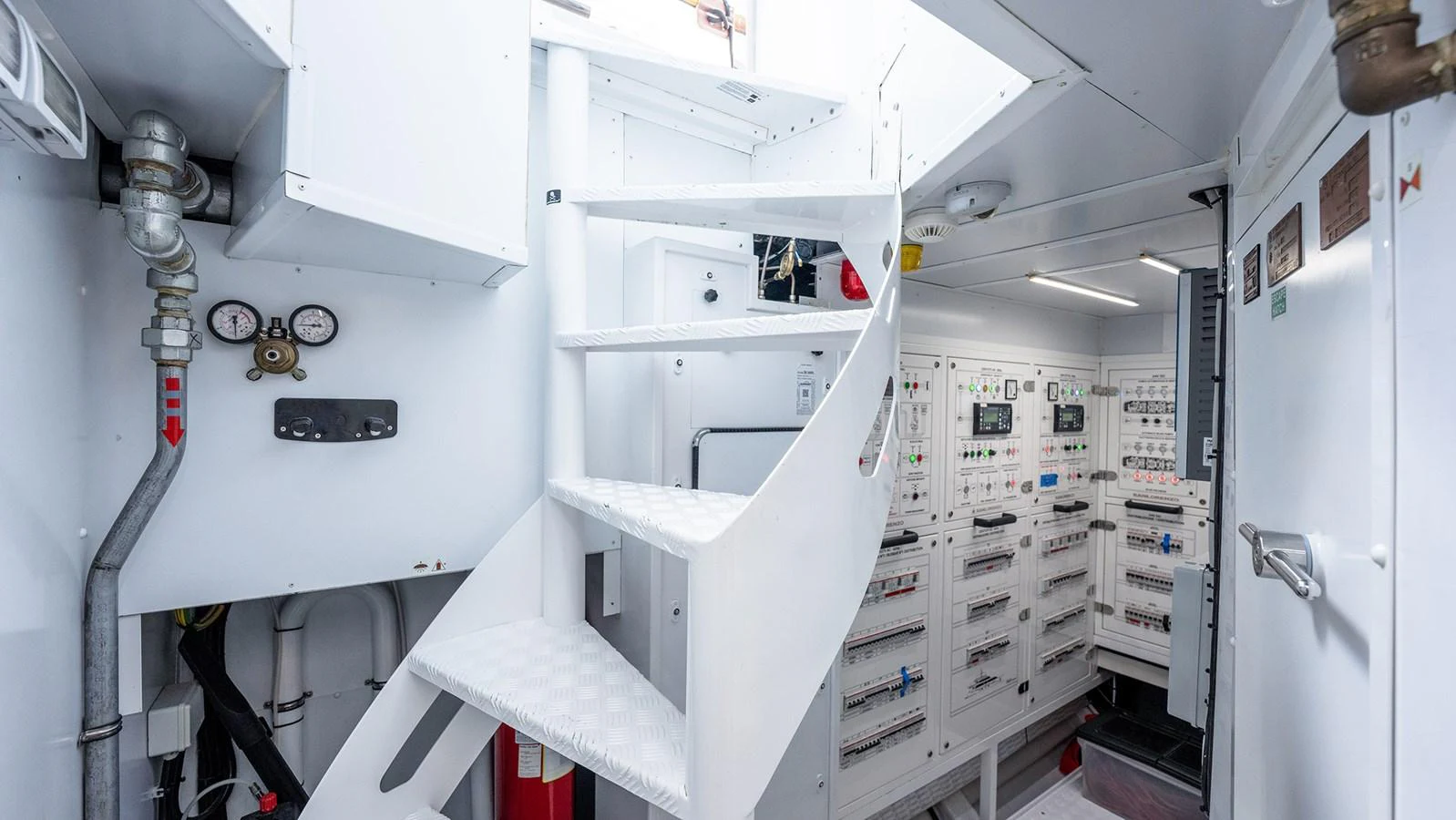 The image showcases the technical room of the yacht, featuring control panels and a staircase. aboard BETTY JANE Yacht for Sale