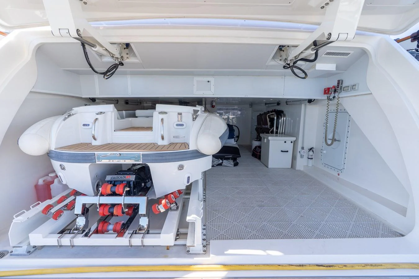 A spacious garage houses a well-equipped tender, ready for adventure. aboard BETTY JANE Yacht for Sale
