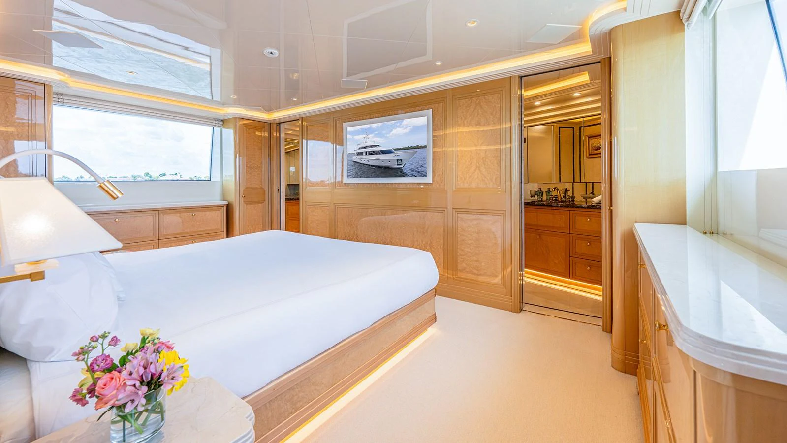 The master stateroom features a luxurious bed, elegant wood finishes, and ample natural light. aboard BETTY JANE Yacht for Sale