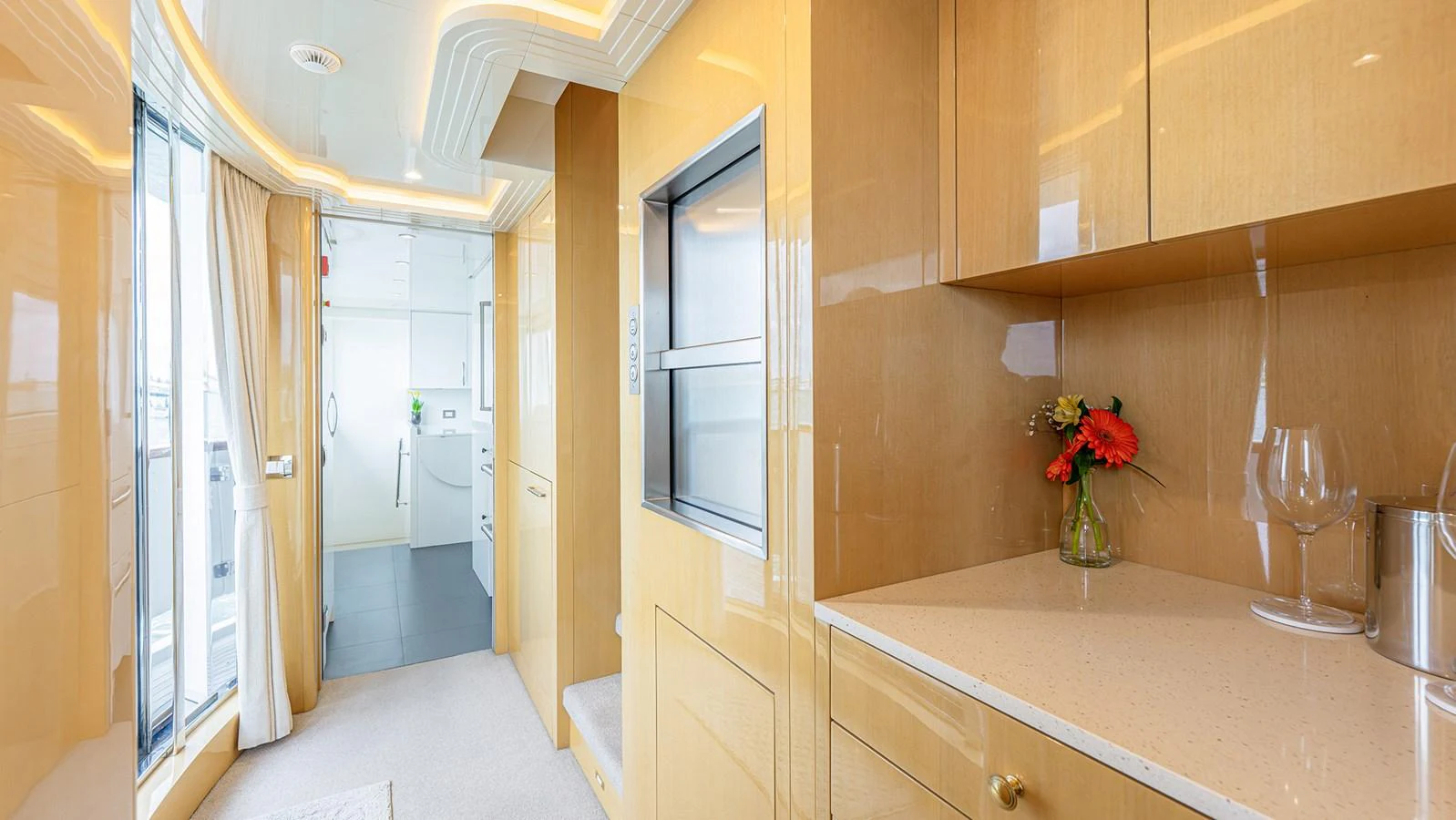 The yacht's interior features a sleek, modern design with light wood finishes and ample natural light. aboard BETTY JANE Yacht for Sale