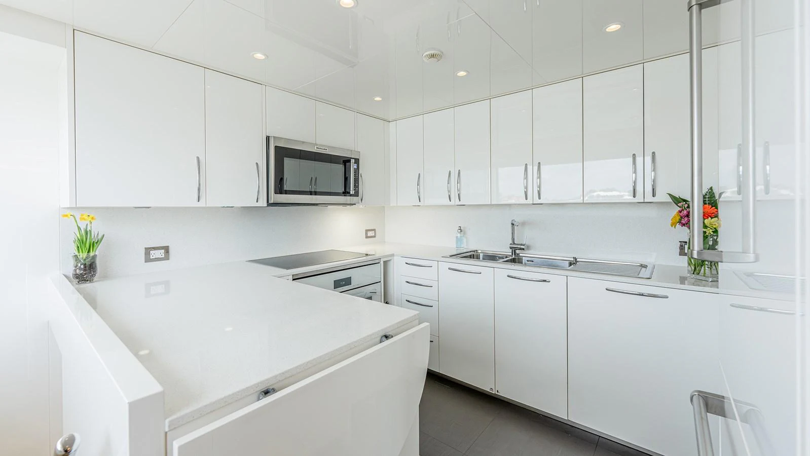 The galley features sleek, modern cabinetry and high-end appliances, creating a bright and functional space. aboard BETTY JANE Yacht for Sale