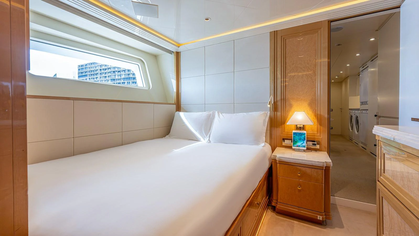 The stateroom features a plush bed with elegant wood finishes and ample natural light. aboard BETTY JANE Yacht for Sale