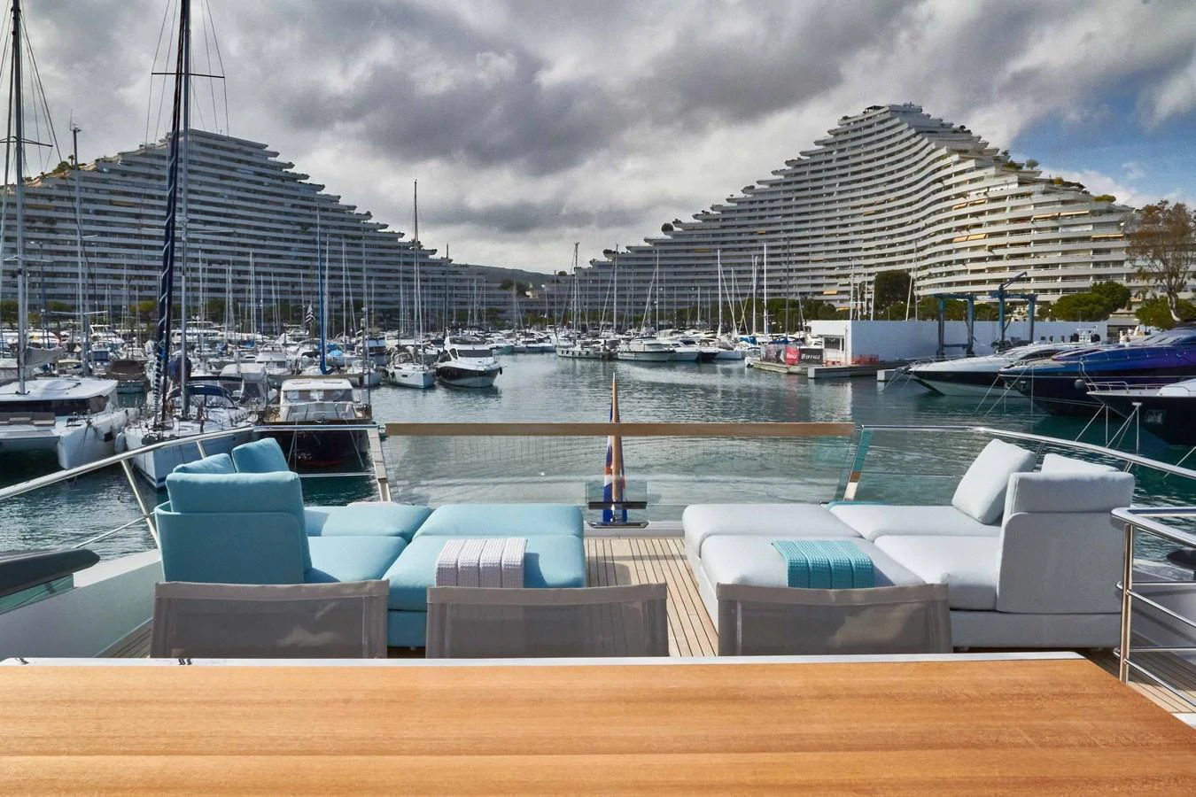 The aft deck offers a serene view of the marina, complemented by luxurious sun loungers and a stylish seating area. aboard KAPUSHA Yacht for Sale