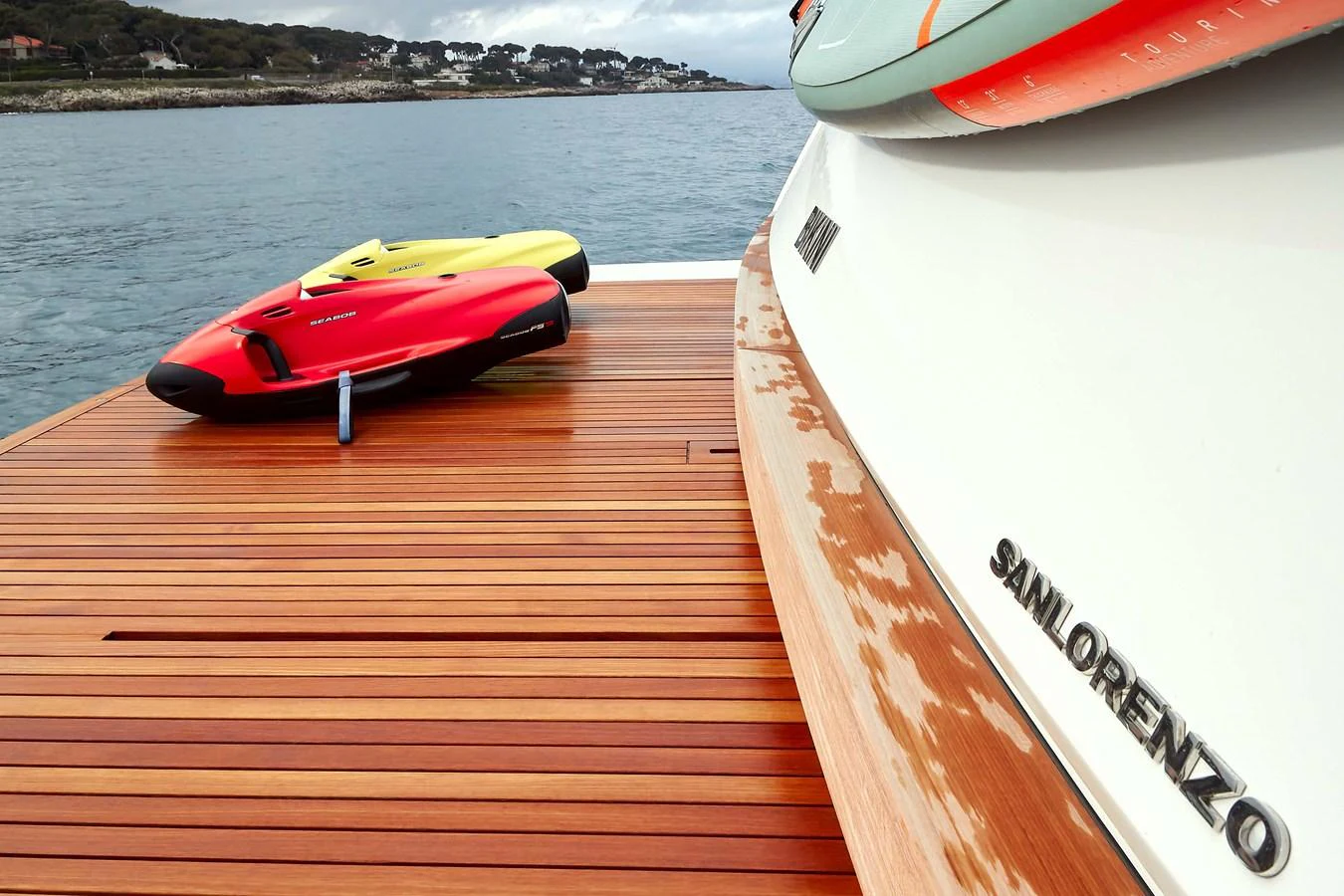 A close-up of the yacht's teak swim platform with two colorful water toys. aboard KAPUSHA Yacht for Sale