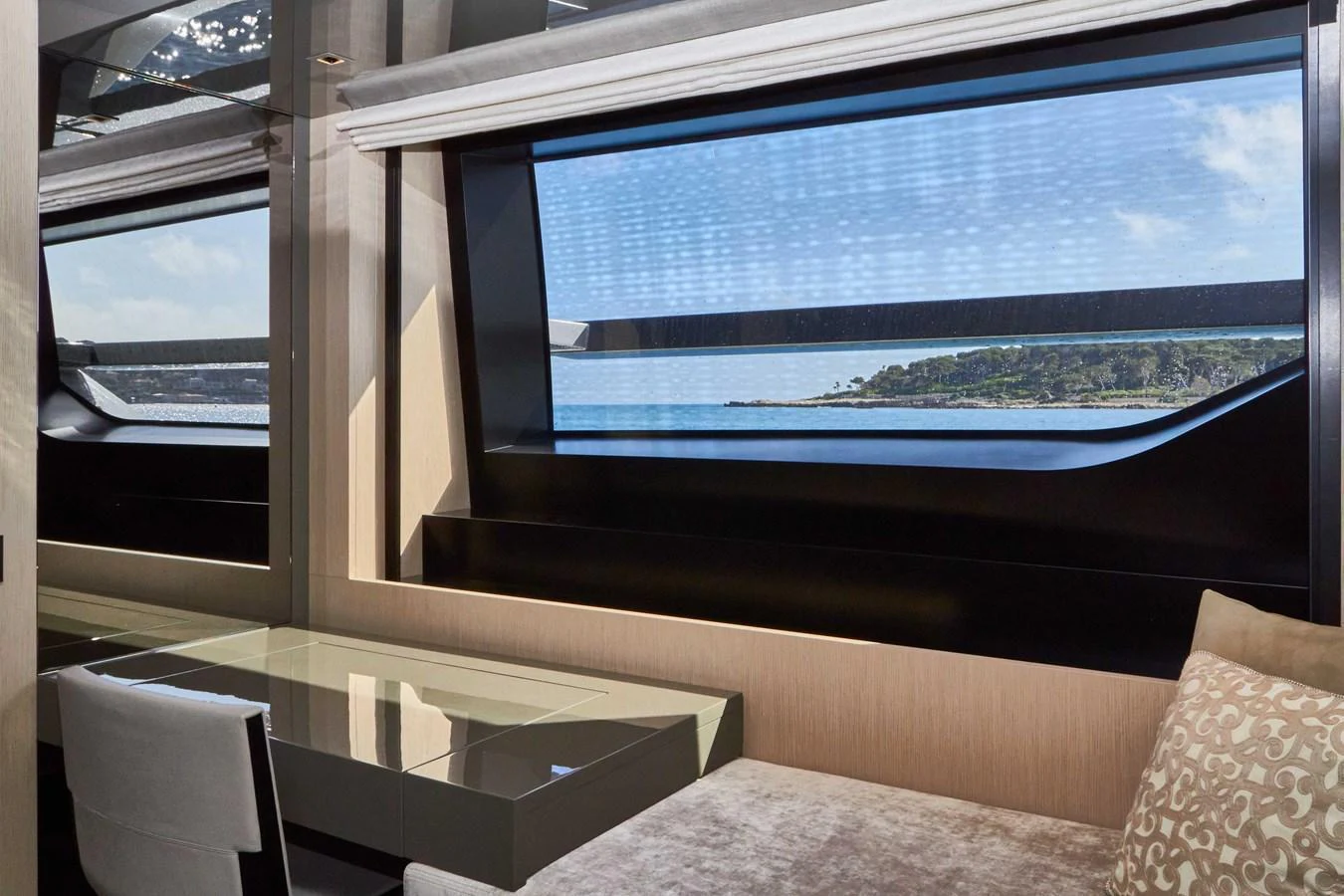 The interior features a sleek and modern design with large windows offering stunning ocean views. aboard KAPUSHA Yacht for Sale