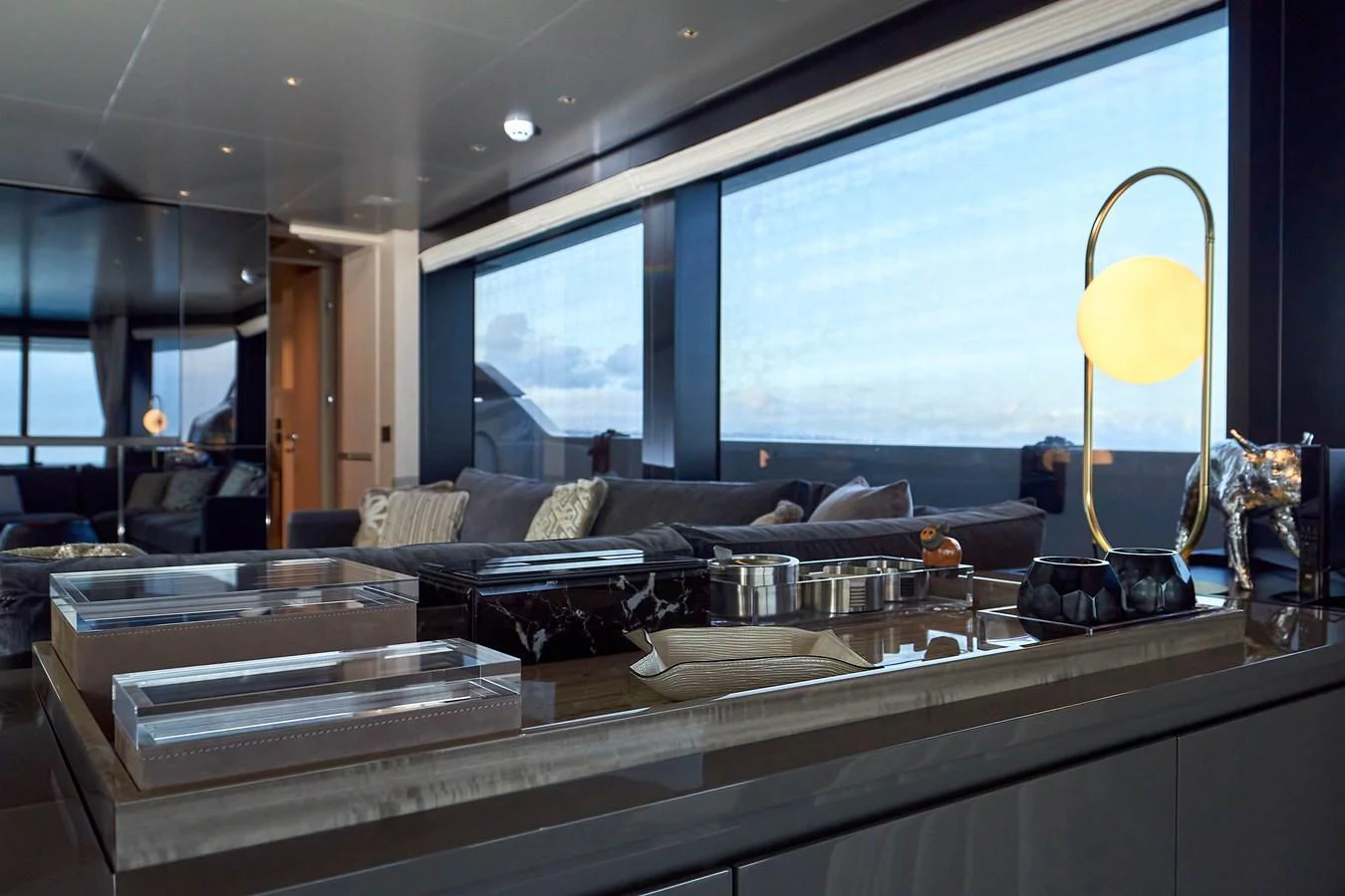The yacht's interior features a modern and elegant lounge area with large windows offering stunning views. aboard KAPUSHA Yacht for Sale