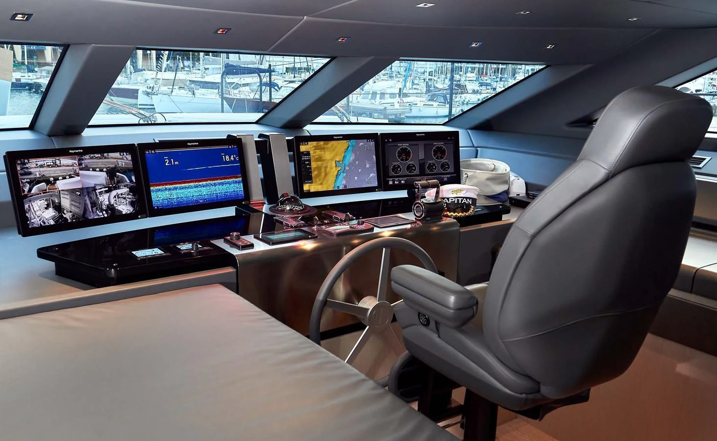 The helm station features advanced navigation equipment and a comfortable captain's chair. aboard KAPUSHA Yacht for Sale