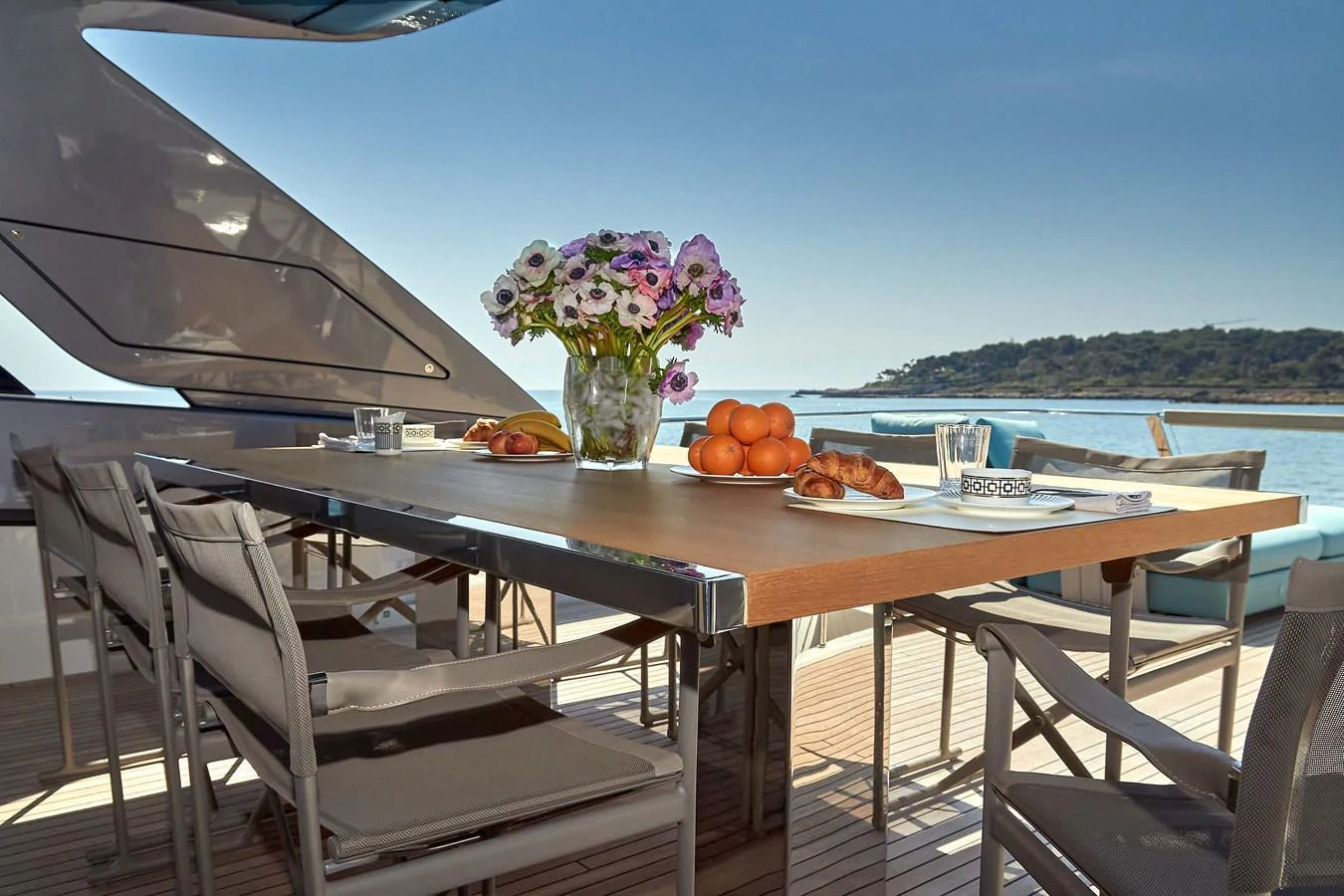 The aft deck features a stylish dining area with a beautiful ocean view. aboard KAPUSHA Yacht for Sale