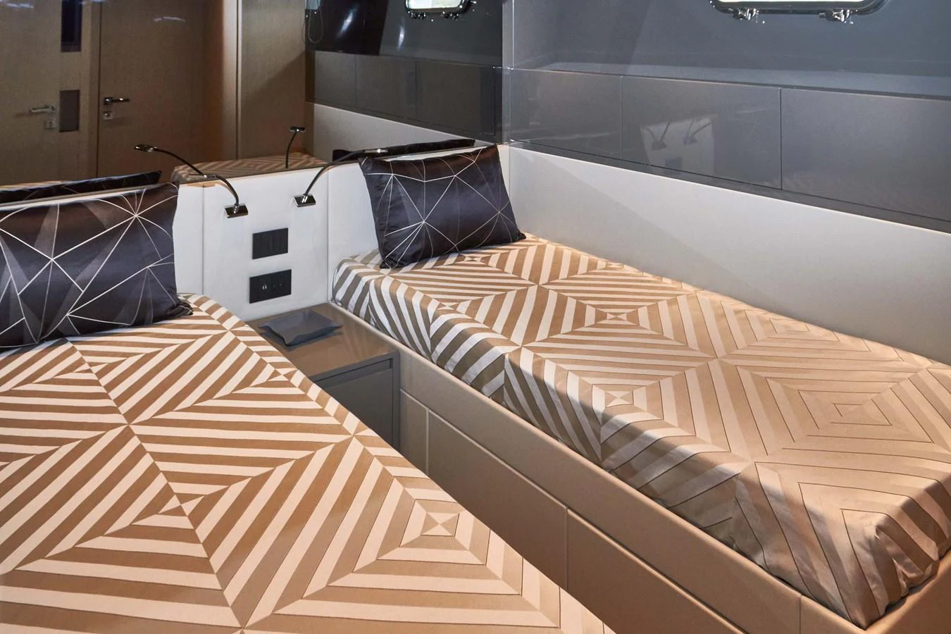 The twin stateroom features modern bedding and sleek design elements. aboard KAPUSHA Yacht for Sale