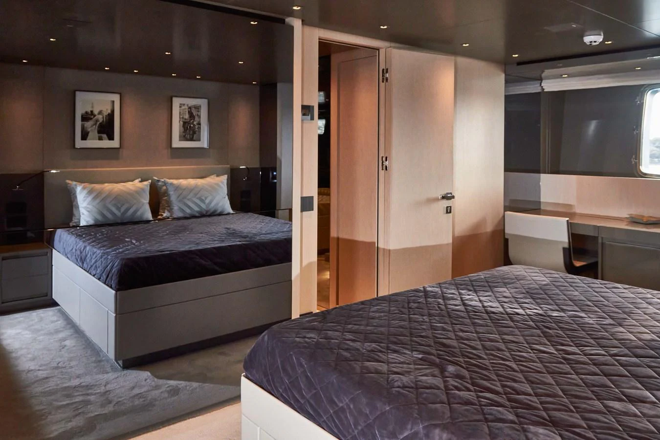The guest stateroom features two luxurious beds with plush bedding and modern decor. aboard KAPUSHA Yacht for Sale
