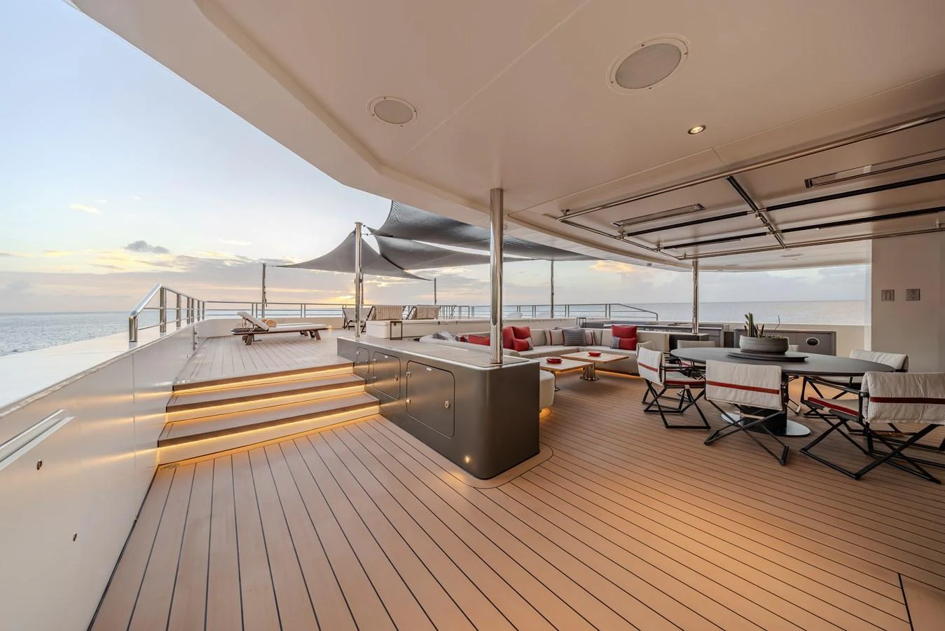 The aft deck offers a spacious and elegant outdoor living area with comfortable seating and stunning ocean views. aboard AKULA Yacht for Sale