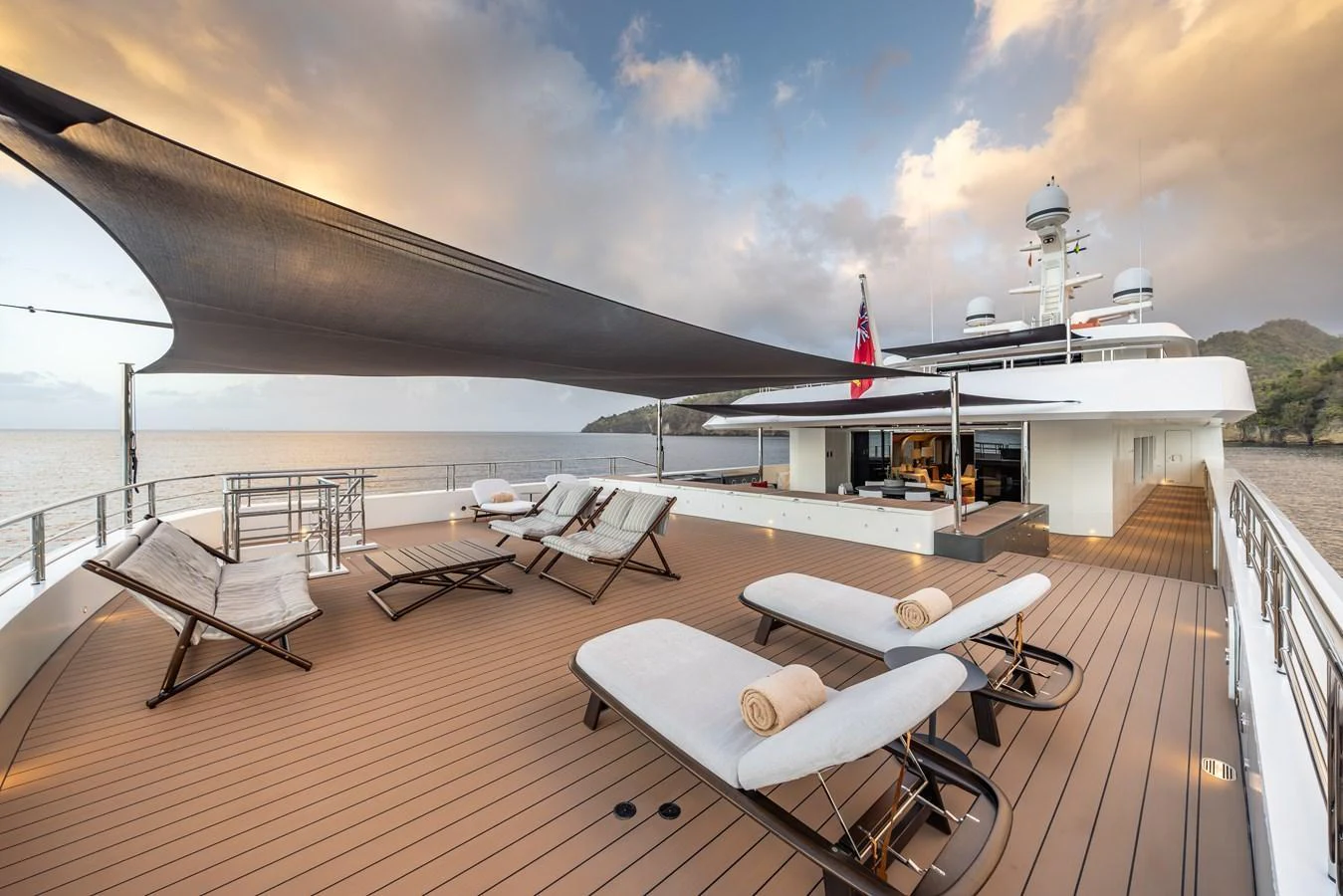 The sundeck offers a luxurious open space with comfortable loungers and a shaded area for relaxation. aboard AKULA Yacht for Sale