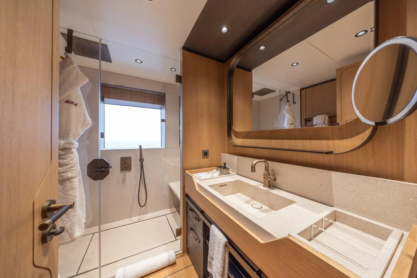 The yacht's bathroom features modern fixtures and a spacious shower area. aboard AKULA Yacht for Sale