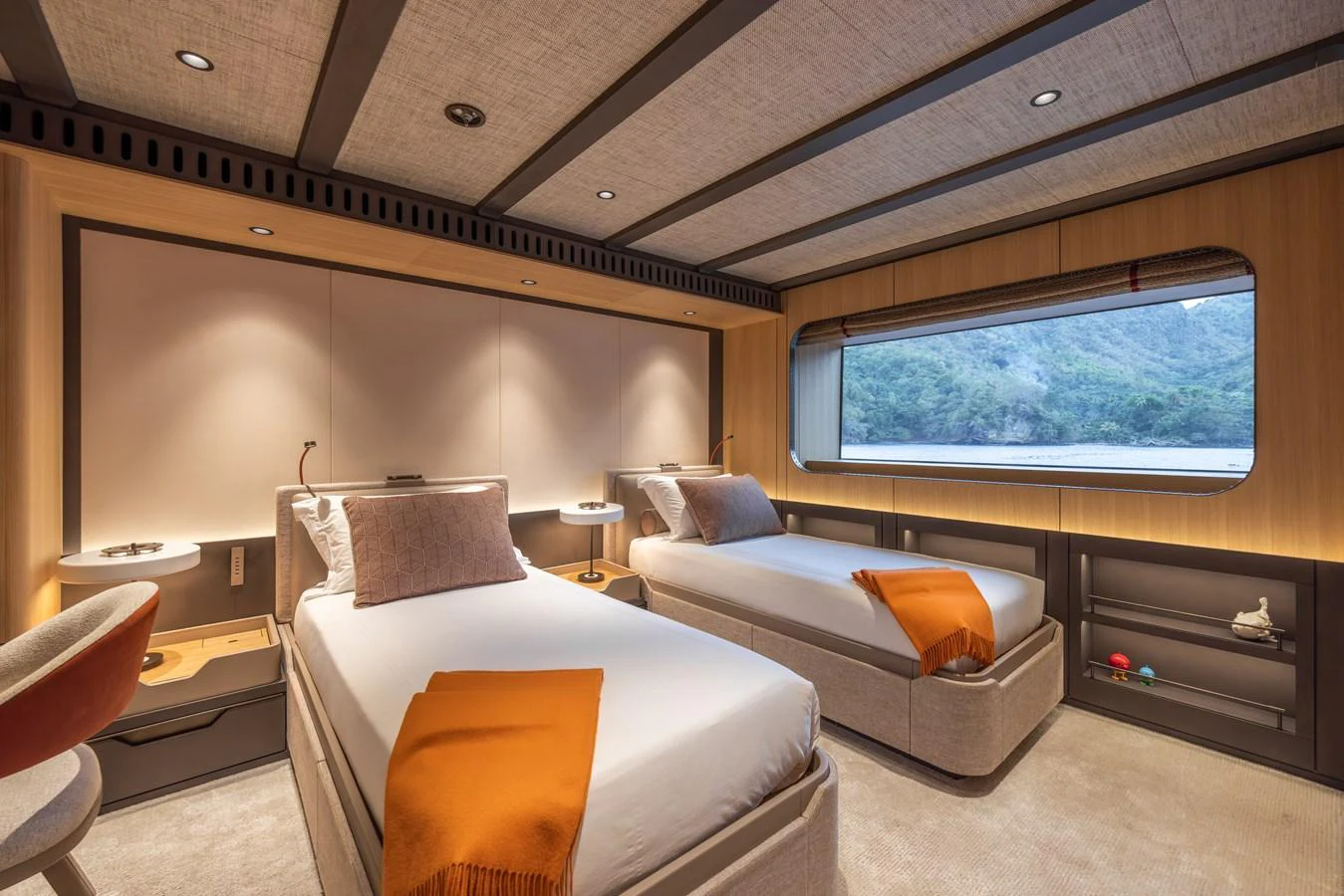 The guest stateroom features twin beds with a large window offering scenic views. aboard AKULA Yacht for Sale