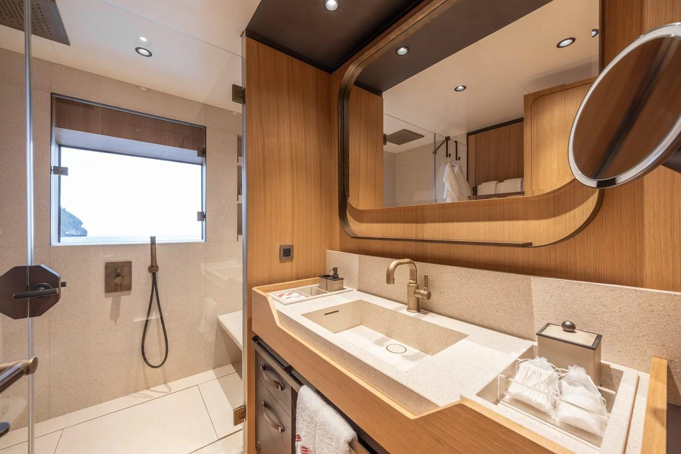The yacht's bathroom features modern fixtures and a sleek design with ample natural light. aboard AKULA Yacht for Sale
