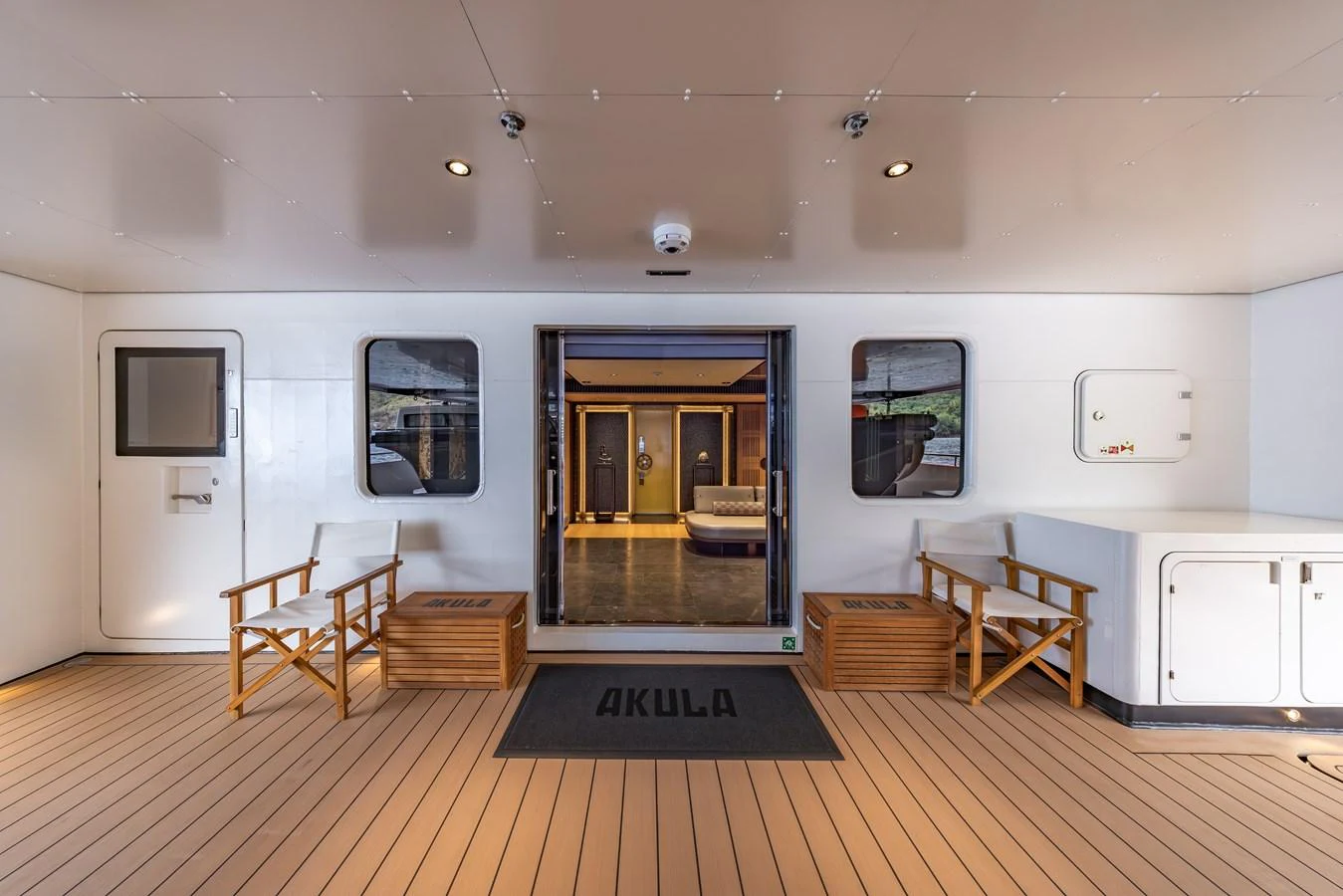 The aft deck features comfortable seating and a welcoming entrance to the interior. aboard AKULA Yacht for Sale