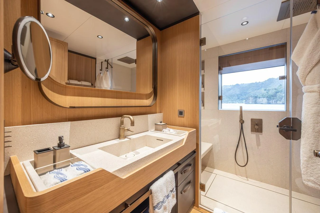 The yacht's bathroom features a modern design with a spacious shower and elegant fixtures. aboard AKULA Yacht for Sale