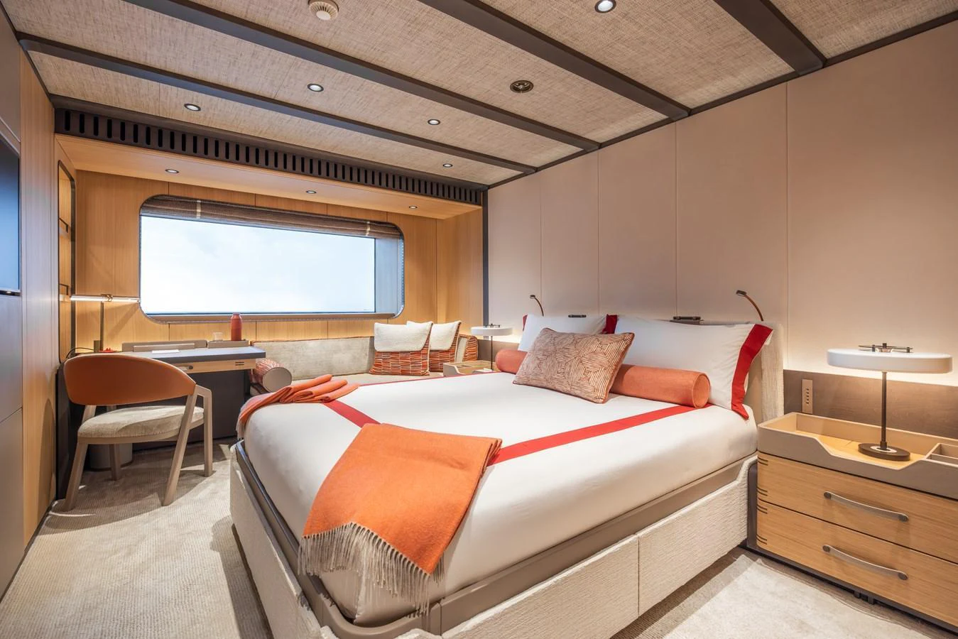 A luxurious stateroom featuring a large bed, desk, and ample natural light. aboard AKULA Yacht for Sale