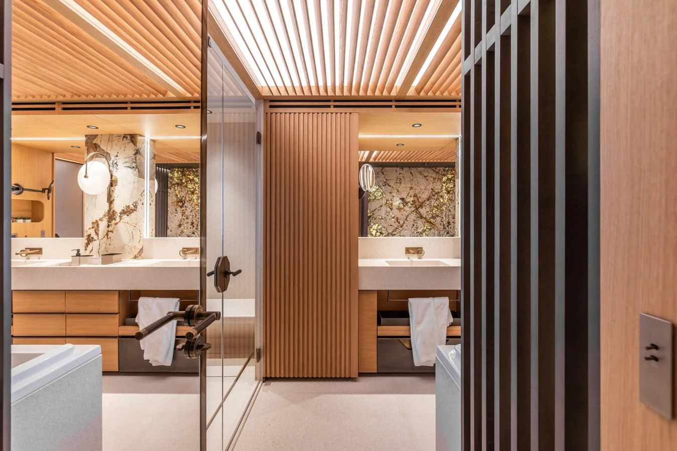 The yacht's bathroom features elegant wood paneling and modern fixtures. aboard AKULA Yacht for Sale