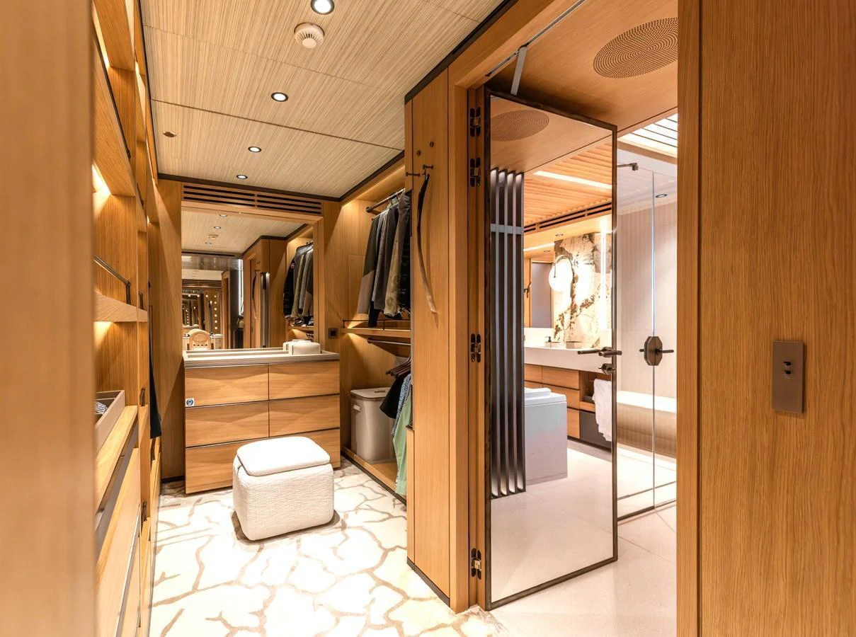 The yacht features a spacious and well-appointed walk-in closet with ample storage and elegant lighting. aboard AKULA Yacht for Sale