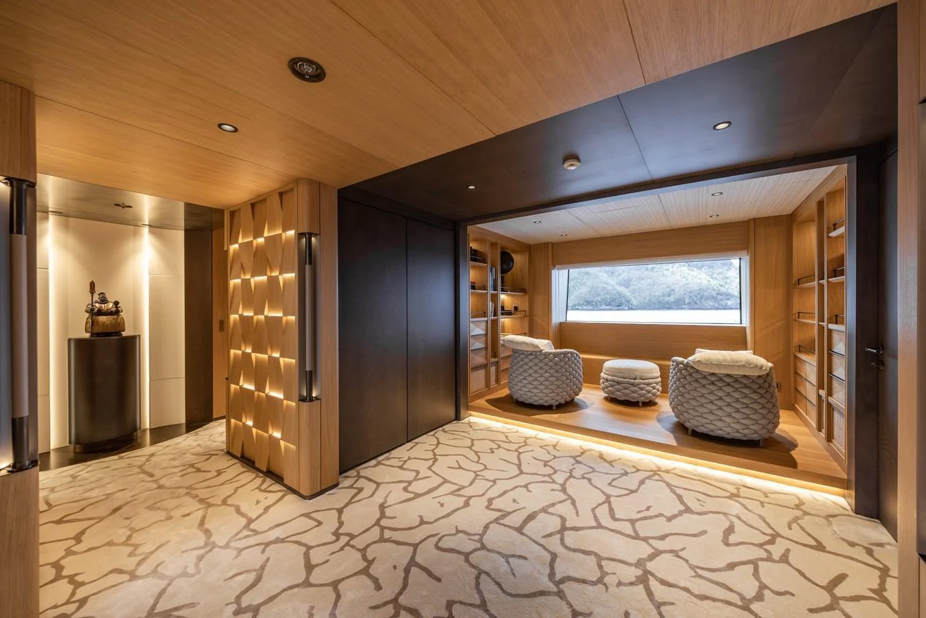 A luxurious lounge area with plush seating and a large window offering scenic views. aboard AKULA Yacht for Sale