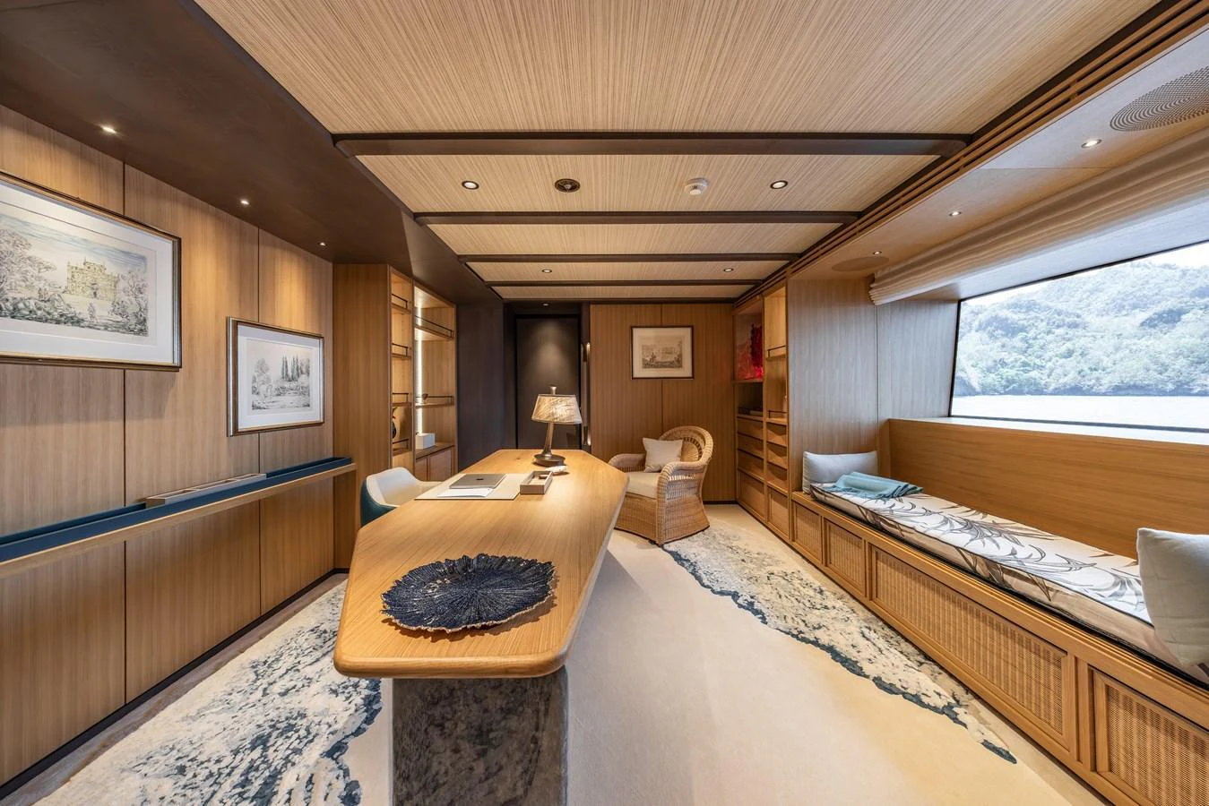 The yacht's office exudes elegance with its wooden finishes and large windows offering serene views. aboard AKULA Yacht for Sale