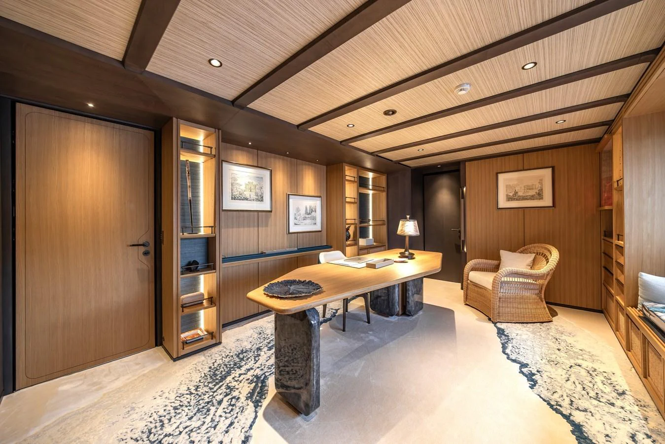 The yacht's office features a sophisticated design with wooden accents and modern lighting. aboard AKULA Yacht for Sale