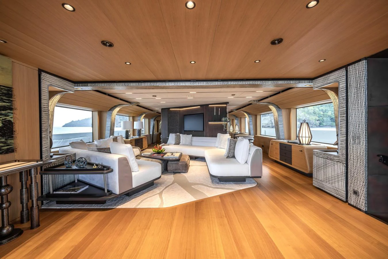 The spacious salon features elegant seating and panoramic windows for a luxurious experience. aboard AKULA Yacht for Sale