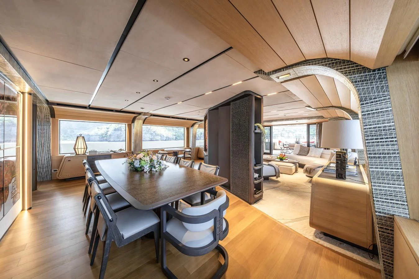 The spacious salon features elegant dining and lounging areas with panoramic views. aboard AKULA Yacht for Sale